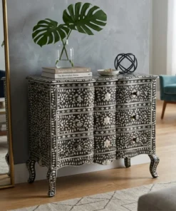 Black mother of pearl inlay fronted wave 3 drawer chest placed in modern living room