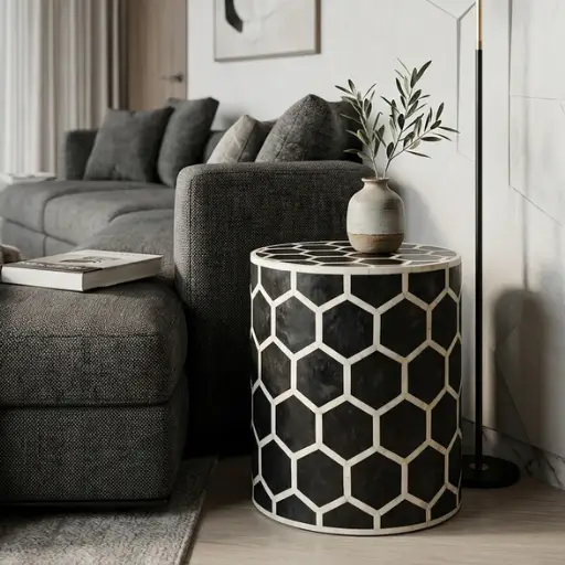 Decorative black bone inlay round side table in modern living room with decor items and books