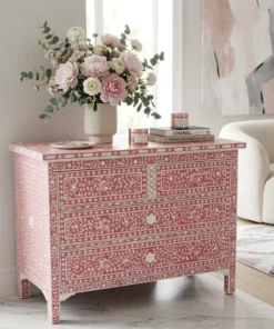 Mother of pearl inlay 4 drawer chest in dark pink placed in modern living room with flower & vase decor