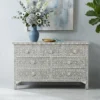 Pale Grey Mother of Pearl 7 Drawer Chest Dresser in modern living room with vase and flower