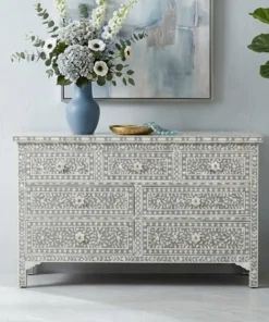 Pale Grey Mother of Pearl 7 Drawer Chest Dresser in modern living room with vase and flower