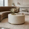 Luxurious White Bone Inlay Round Center Table in minimalist luxury living room with beige sofa and decor items.
