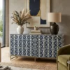 Handmade Navy Blue Bone Inlay Chest of 6 Drawers featuring an elegant Ikkat Design placed in modern living room with green chair and decor items