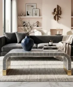 Luxury navy blue bone inlay waterfall coffee table in contemporary living room with dark grey sofa and wall decor items