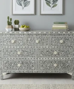 Grey mother of pearl 7 drawer chest dresser is handcrafted with detailed shell inlay work and placed in living room with decor items