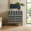 Handmade navy blue bone inlay storage cabinet in modern living room with decor items