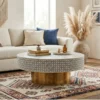 Round bone inlay coffee tale place in bohemian living room setup with sofa and rugs