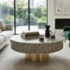 Black bone inlay designer coffee table in modern living room with sofa and decor items