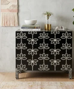 Black bone inlay lotus floral design sideboard placed in modern room with books, vase and plant