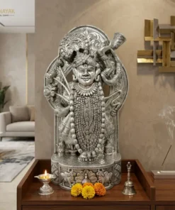 Handmade Silver lord shrinathji statue placed at modern living room with flower and pooja items