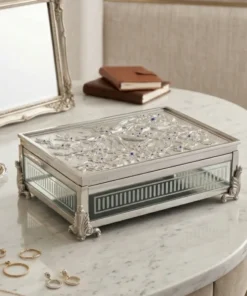white metal jewelry storage box placed on luxury dressing table with items