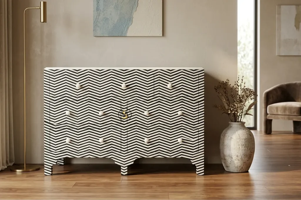 Black and white bone inlay chest of drawers with zigzag pattern styled in modern living room 