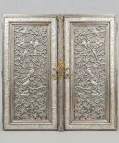 German silver carved temple double door with matching ornamental frame in a luxury temple entrance