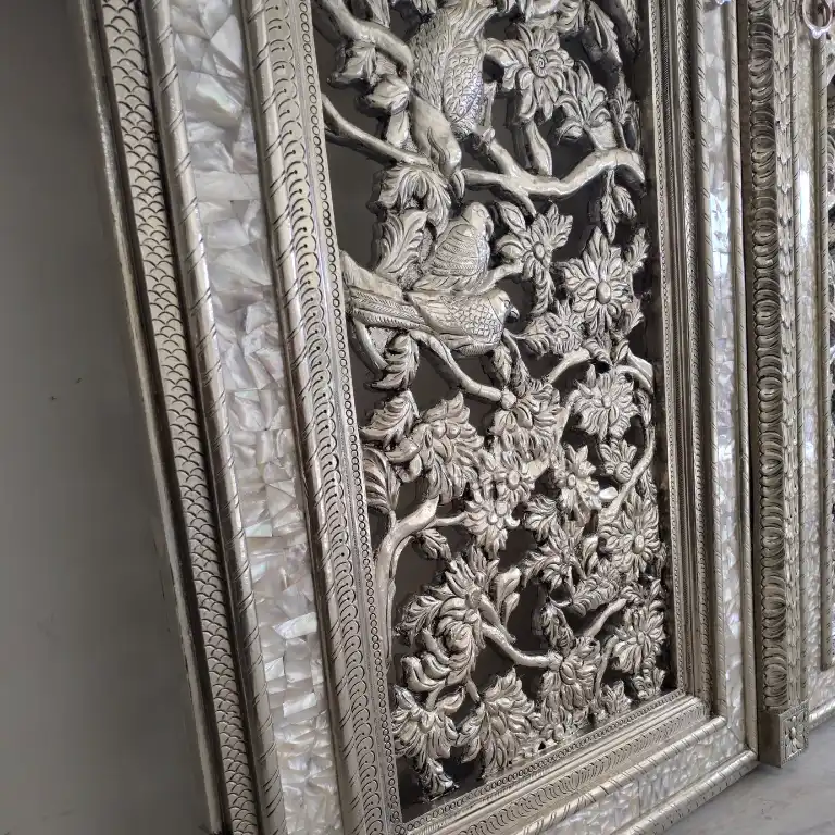Ornamental leaf carvings on the frame of a German silver temple double door